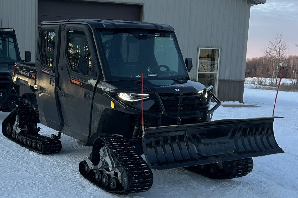 Two UTVs, one has a snowplow on it